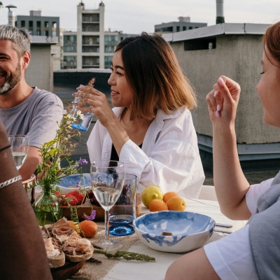 A woman at the center of a social dinner.